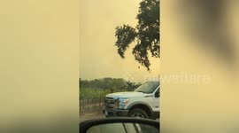 Helicopter collects water to battle raging Glass Fire in California wine county