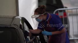 Behind-the-scenes photographs show the process of a COVID test in the UK