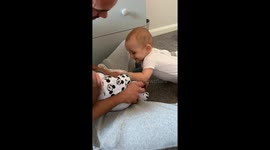 Baby can't hide his delight as he meets newborn little brother for the first time
