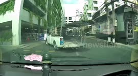 Dozens of iron bars fall onto car from overloaded pickup truck in Thailand