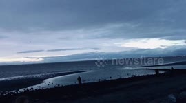 Beach stroll at dusk on a cloudy evening