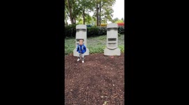 Boy getting a fright from lego land statues for halloween