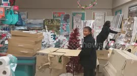 Workers getting Christmas trees ready in grocery store and it is only the start of October month.