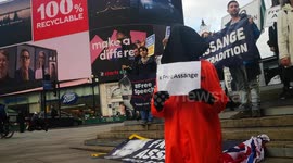 #freeassange protester dressed as an inmate at picadilly circus