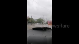 Cars drive through flood water during Tropical Storm Gamma in Mexico