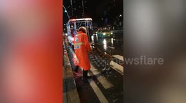 Hero policeman helps stray dog across busy road during floods in Bangkok