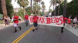 'Tax Bezos'! Protesters march to world's richest man's mansion to demand Amazon owner pay more