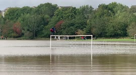 A daredevil flipped off a goal post into a seven foot deep flooded football pitch - wearing a wetsuit, snorkel and flippers