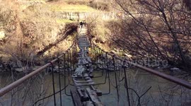 Would you dare? Man crosses rickety bridge in abandoned area of Armenia