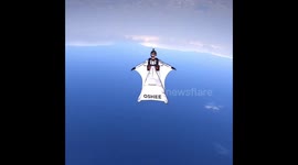 Polish wingsuit pilot glides on top of the world