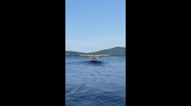 Water plane taking off on lake