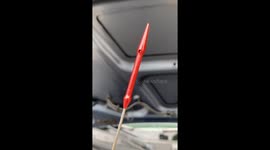 Checking the dipstick on a Mini Cooper