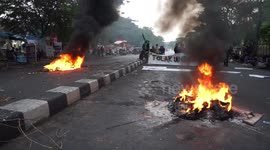 Indonesian students set tires on fire during protest against government's jobs law