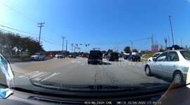 Instant karma as red light runner doesn't notice police car right next to them