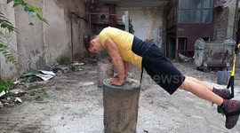 Fitness fanatic shows off his determination by working out in derelict building