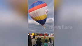 Chinese worker dragged into air while inflating hot air balloon due to sudden gust of wind