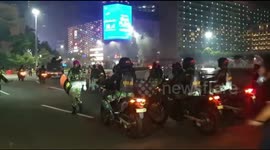 Police shot tear gas at thousands of anarchist protesters burning the bus stop in Jakarta, Indonesia