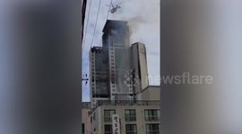 Helicopters drop water on smouldering apartment block in Ulsan, South Korea