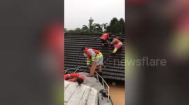 Brave policeman piggybacks stranded woman during floods in Vietnam