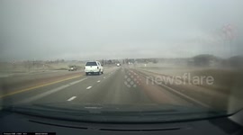 Ice falls from a post onto a driving car. Dash Cam