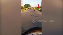 Passengers Ride On Metal Bars On Truck