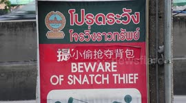 Signs warning tourists of s natch thieves in Bangkok, Thailand