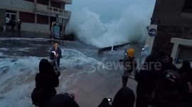 French TV reporter DRENCHED by huge wave