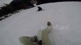 Snowboarders crash during sit-down descent
