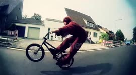 BMX Biker does amazing Wheelie in Bear Costume