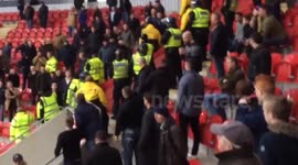 Millwall fans clash with security at football match