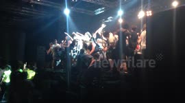 Concertgoers fight security to invade stage