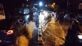 Vehicles drive through flooded streets in Bengaluru, India
