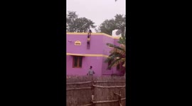 Lucky escape for boy hanging from the roof of a building in India