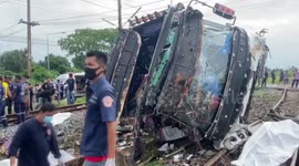 Horrific aftermath of crash between train and bus in Thailand