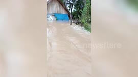 Roads turned to rivers after flooding bursts through streets in Cambodia