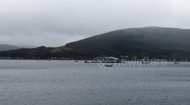 Submarine and Merlin helicopter on Loch Long in Argyll Scotland