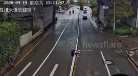Chinese man gets stuck on central reservation fence after trying to climb over it