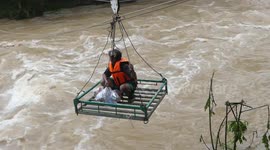 Buddhist monks use zipline to send food to villagers cut-off by floods in Thailand