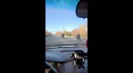 Motorcycle rider pops a wheelie on his Harley in Anchorage traffic