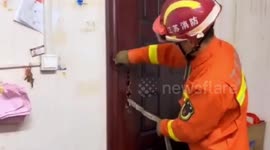 Firemen rescue snake trapped in door at Chinese supermarket