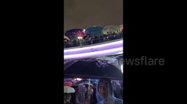 Thailand: People On Bridge Drop Umbrellas To Protesters Below During Pathum Wan Intersection Protest