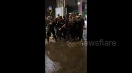 Police in Thailand carry and arrest protestor during clashes