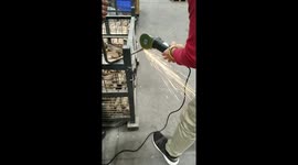 The men cutting metal with cutting tool .