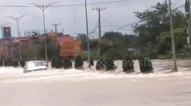 Car struggles through flooded road in Phnom Pen, Cambodia