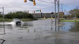 Car driving through flooded road. Charleston, South Carolina.