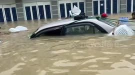 Locals battle to save car and possessions during flooding in Cambodia