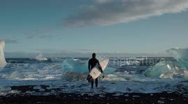 Incredible footage shows the moment intrepid surfers took to the waves in the arctic circle - dodging ICEBERGS