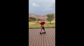 US girl does yoga poses while balancing on rotating hoverboard