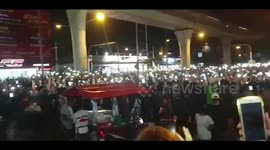 Pro-democracy protesters shine their mobile phone lights during rally in Bangkok