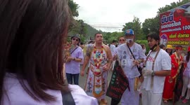 Walk around festival where religious devotees pierce their cheeks with skewers